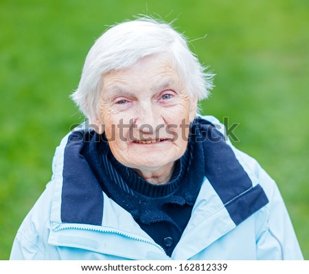 Portrait Of The Smiling Elderly Woman On Outdoors