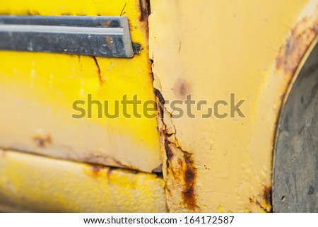 Close up photo of rusty yellow car