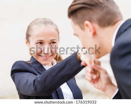 Young businessman greet polite his partner with kissing hand
