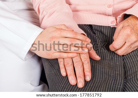 Young doctor giving helping hands for elderly woman