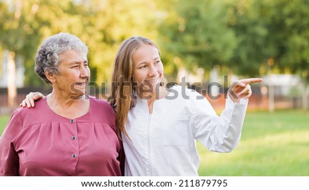 Elderly woman with her caretaker in the nature