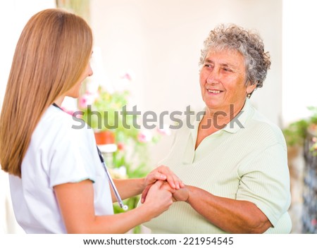 Photo of happy elderly woman with the young doctor