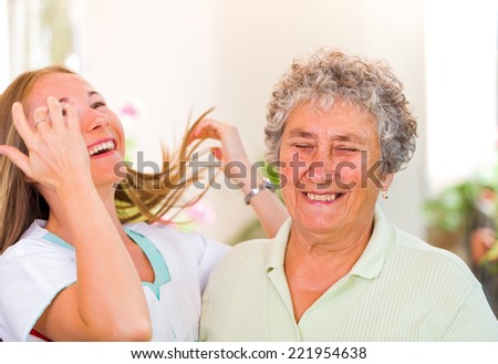 Snapshot of an elderly woman with her daughter having fun