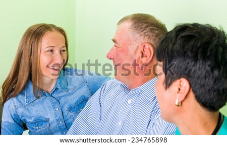 Photo of an old man with his daughters