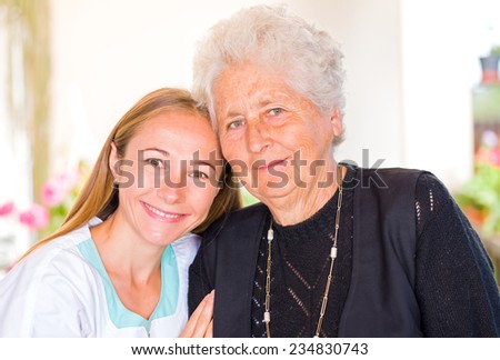 Photo of happy elderly woman with her caregiver