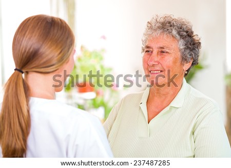Photo of happy elderly woman with her caregiver