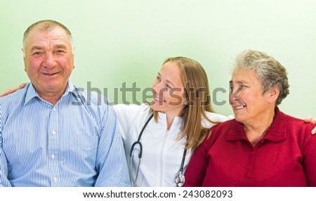 Photo of happy elderly couple with the young doctor