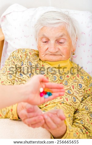Photo of elderly woman taking the medication