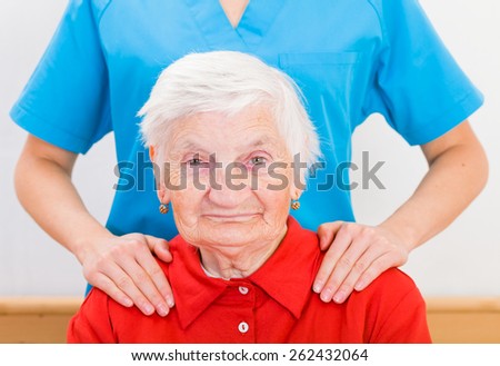 Photo of elderly woman supported by young doctor