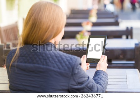 Photo of young blonde woman reading the news