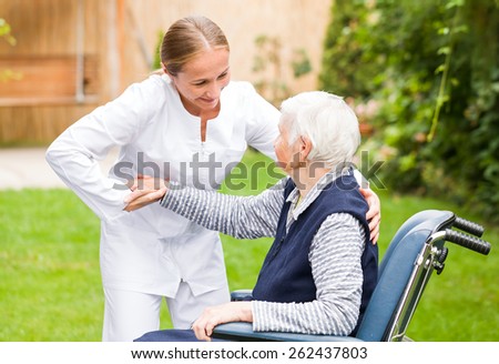 Photo of young carer helping the elderly woman