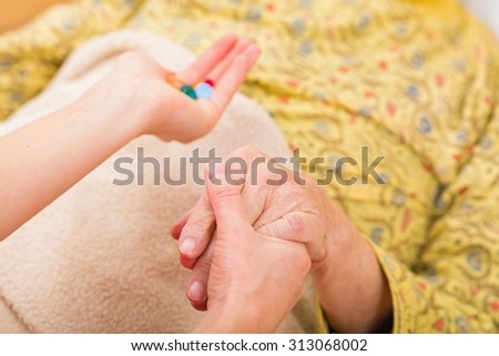 Photo of elderly woman taking the medication