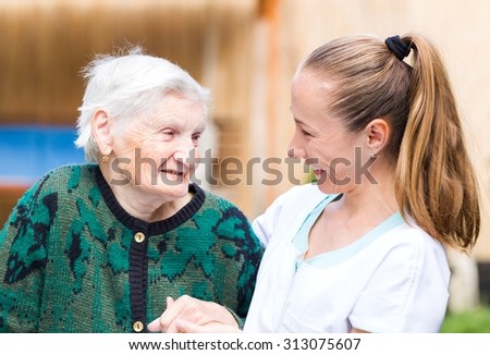 Photo of elderly woman with her caregiver