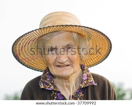 Old woman whit hat in the garden
