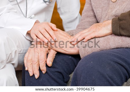 Young doctor holding the lady\'s hand