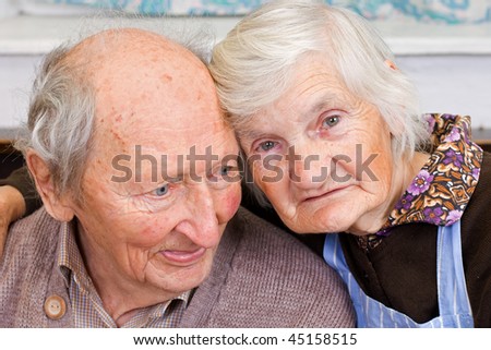old happy grandparents staying together on the bed