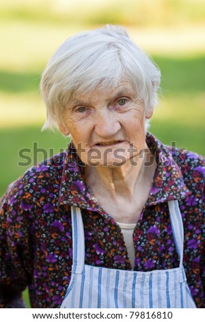 Elderly lonely woman in the nature