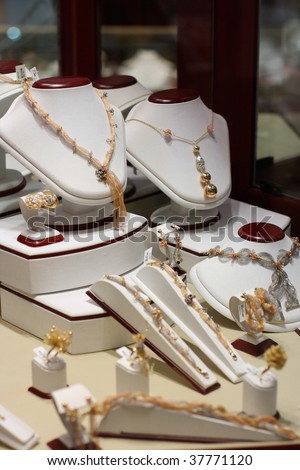 Golden necklaces in jewelry showcase shopping.