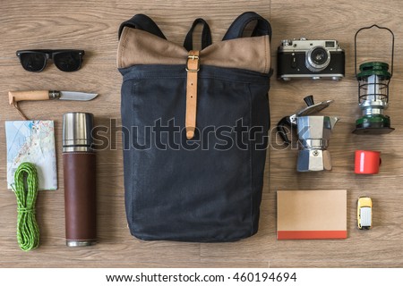 Top View of Travel Stuff on Wood Background, Camping and Coffee, (Backpack, Notebook, Map, Rope, Knife, Coffee Pot and Sunglasses)