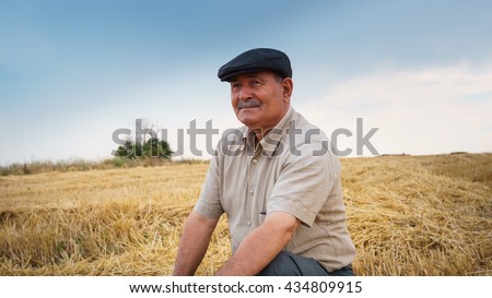 Farmer sitting in the field, waiting for his crop