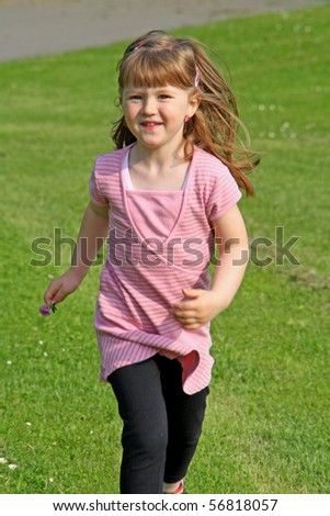 Young girl running in the garden