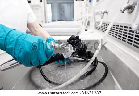 hand with glove  is cleaning hospital equipment