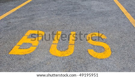 Yellow bus sign on tarmac road