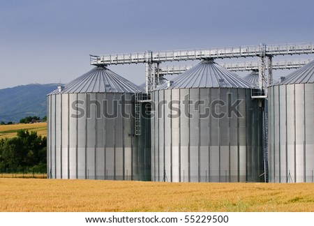 Grain store in wheat field with hills in background