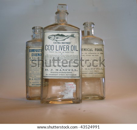 selection of old medicine bottles on plain background with soft lighting