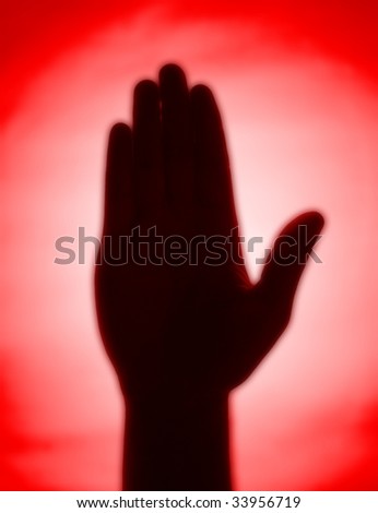 Red back-lit hand signaling \'stop\'