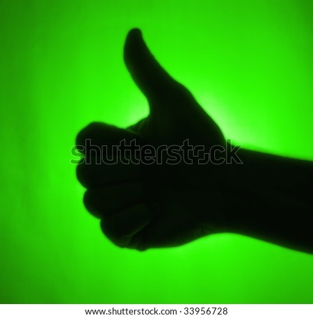 Green back-lit hand signaling \'thumbs-up\'