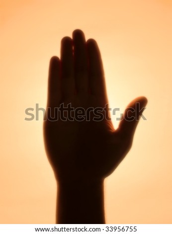 Back-lit hand signaling \'stop\'