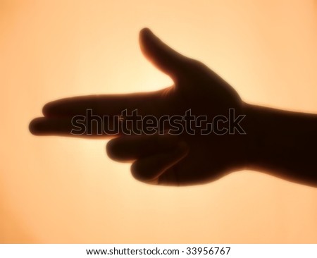 Back-lit hand signaling \'pistol\'
