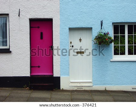 Pink front door to pastel cottages