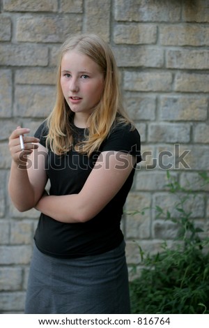 Teen smoking first cigarette -  Soft Focus [set up picture using a stage prop cigarette]