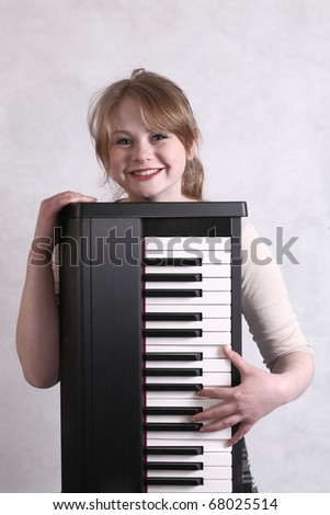 Young teen musician with her keyboard