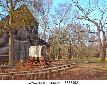 Covered wagon and old barn