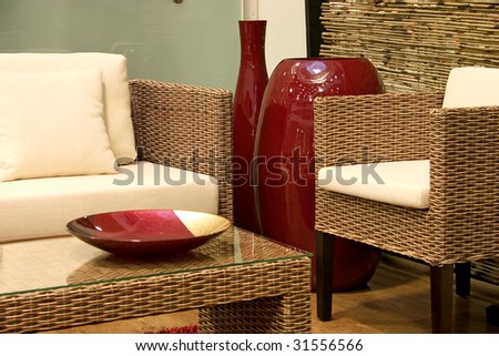 Close up of living room with sofas from rattan and arm chair.