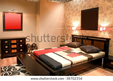 Interior of modern bedroom with furniture floral wallpapers and hot colors.
