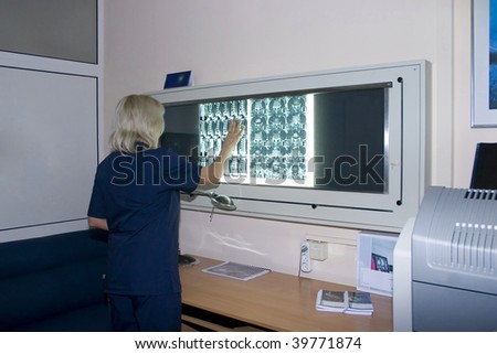 Interior of a doctor room with doctor joint specialist whatching film.