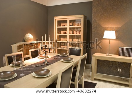 Luxury dining room and dinig table with glasses, dishes and furniture.