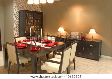 Luxury dining room and dinig table with glasses, dishes and furniture.