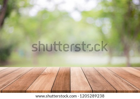 Empty wooden table with blurred green background with a country outdoor theme,Template mock up for display of product