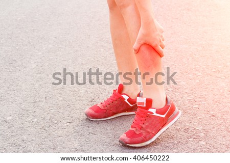 woman runner leg and muscle pain on  road in morning