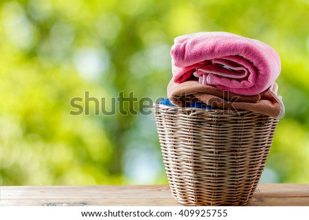 Towel in a laundry basket on natural background