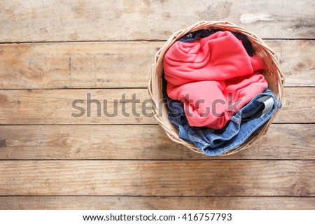 Top view Clothes in a laundry basket on Wood floor