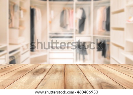 Empty wooden table on a background blur closet in the room  for display or montage your products