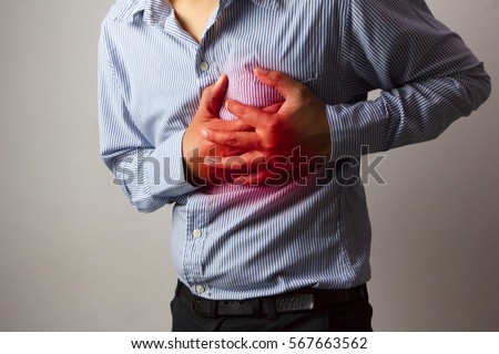 Man having heart ache / holding hand on her chest / Heart attack or stroke/ Health care concept.