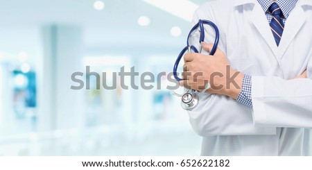 Doctor with a stethoscope in the hands behind on the hospital background / Medical concepts and health care