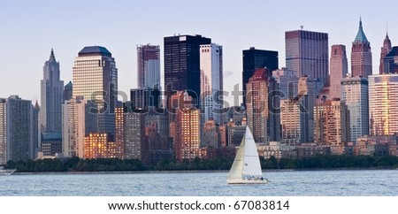 A sailboat in front of the majestic New York City Skyline. Useful as a concept photograph of New York.